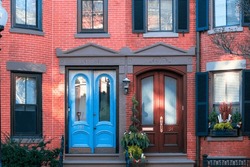 Vintage Neighboring Entrance Doors To The House, Front Red Brick Wall Building Street View