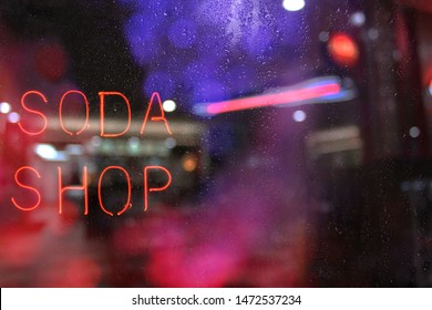 Vintage Neon Soda Shop Sign In Rainy Window