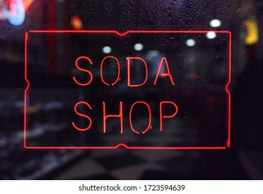 Vintage Neon Soda Shop Sign In Rainy Window