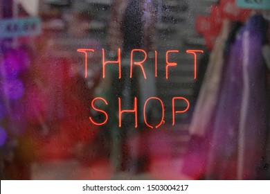 Vintage Neon Thrift Shop Sign In Wet Window