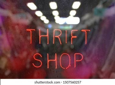 Vintage Neon Thrift Shop Sign In Wet Window