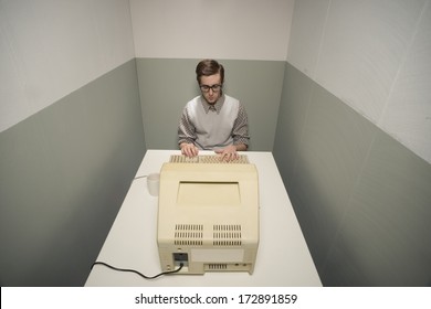 Vintage Nerd Guy Working On Old Computer In A Small Room.