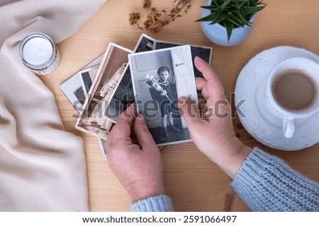 vintage Nostalgic photo album with blank space for picture on wooden table, surrounded by memories and keepsakes, concept genealogy, memory ancestors, family ties, sentimental atmosphere