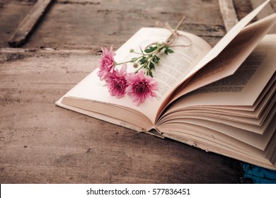 Vintage Novel Books With Bouquet Of Flowers On Old Wood Background - Concept Of Nostalgic And Remembrance In Spring Vintage Background 