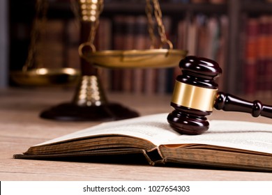 Vintage Office Room In Suprime Court With The Scales Of Justice And  Legal Hammer On The Table With Law And Codex Books Library In The Background