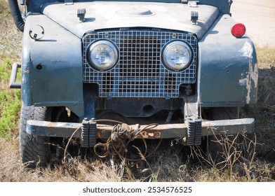 Vintage off-road vehicle close-up: rugged grille and headlights in nature - Powered by Shutterstock