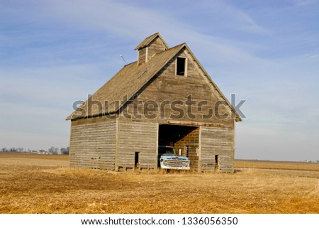 Vintage old barn or corn crib in Central Ill.  This one has an old blue pickup truck parked inside.  You can almost feel history oozing out of these old structures.