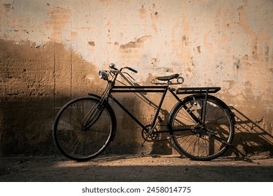 Vintage old bicycle leaning against dirty old wall background. Classic bike on decay wall with retro style. - Powered by Shutterstock