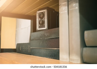 Vintage old camera over stack on books shelf. vintage filter