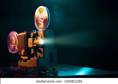 Vintage old fashioned projector in a dark room projecting a film, cinematography concept