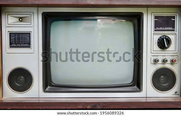Vintage old fashioned\
TV isolated in home. Classic retro style old television with wooden\
door type. 