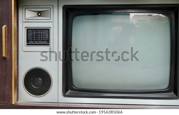 Vintage old fashioned TV isolated in home. Classic\
retro style old television with wooden door type. Vintage\
Television for sale.