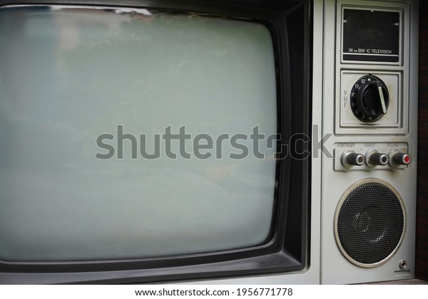 Vintage old fashioned\
TV isolated in home. Classic retro style old television with wooden\
door type. 
