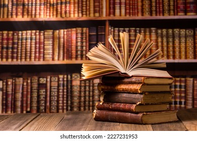 Vintage old hardback books, diary, fanned pages on wooden desk table and grunge background Daylight. Books stacking. Back to school. Copy Space. Education background - Shutterstock ID 2227231953