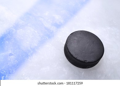 Vintage Old Hockey Puck Is On The Ice Near The Blue Line