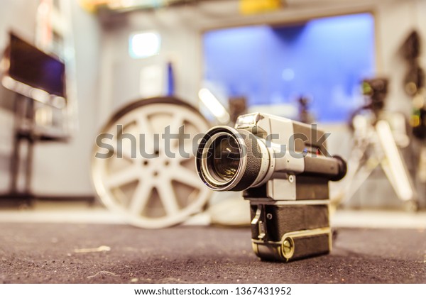Vintage old movie camera, production studio in
the blurry background