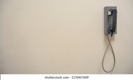 Vintage Old Phone Mounted On A White Wall / Space For Text