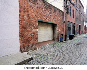 Vintage Old Red Brick Carriage Garage Wall Cobblestone Street In Hoboken New Jersey