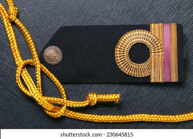 Vintage And Old Royal Thai Navy Arm Put Beside Gold Color Rope Represent Thai Navy Arm Accessory To Use With Uniform .