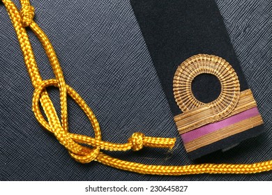 Vintage And Old Royal Thai Navy Arm Put Beside Gold Color Rope Represent Thai Navy Arm Accessory To Use With Uniform .