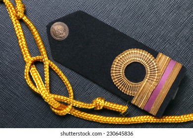 Vintage And Old Royal Thai Navy Arm Put Beside Gold Color Rope Represent Thai Navy Arm Accessory To Use With Uniform .