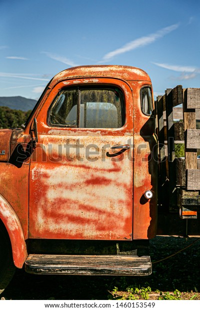 Vintage old rusted pickup truck with wooden back
for farming and hauling
crops