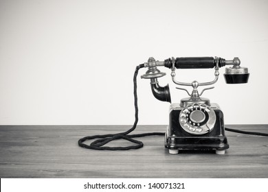 Vintage Old Telephone On Wood Table Black And White Photo