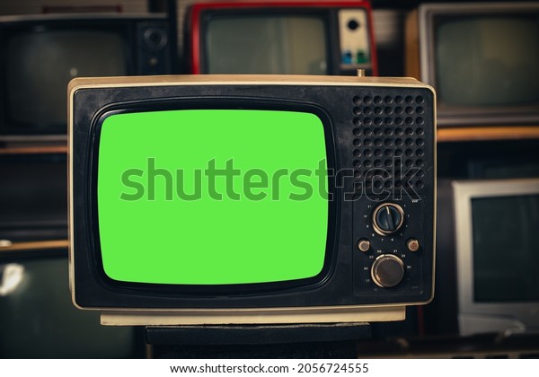 Vintage old  TV with\
green screen in room.