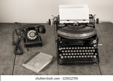 Vintage Old Typewriter, Phone, Book On Table Desaturated Photo