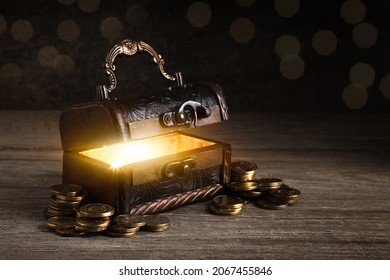 vintage open chest, coins on a wooden table, bright light from inside the chest, fabulous wealth concept, pirate treasures, pandora's box, in search of treasure, fairy tale