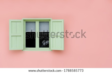 Vintage opened green mint shutters and wooden windows isolated on pink background with copy space and clipping path.