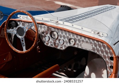 vintage open-top car at the yacht show in Monaco on a sunny day, leather seats, spoked wheels, close-up - Powered by Shutterstock