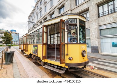 Vintage orange tram on the street of Milano near city center,  Lombardia region, Italy.