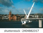 Vintage Panorama of peace bridge in Derry or Londonderry spanning across the river on a sunny spring day. Beautiful modernist bridge to the derry old town.