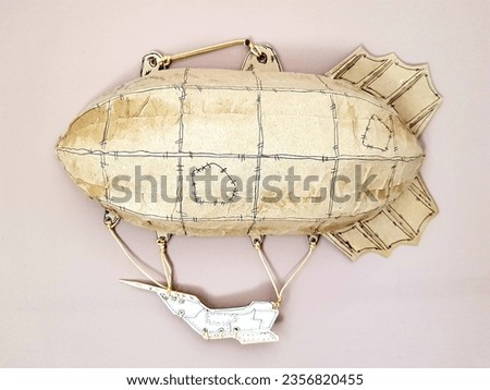 Vintage paper airship with map on pink background