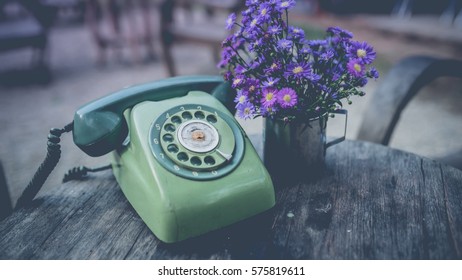 Vintage Pastel Green Rotary Telephone On Grunge Wooden Desk.