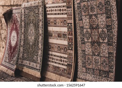 Vintage patchwork background on retro handmade carpet. Patterns on texture of old blanket surface.