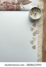 Vintage Patterned Tissue Paper With Copy Space Of A Handmade Candle, Craft Lace, Jute Ribbon And Wooden Hearts.