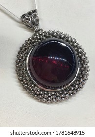 Vintage Pendant With A Large Round Red Mexican Amber In A Silver Frame. Photo For Decoration Jewelry Store.