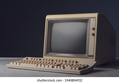 Vintage personal computer with keyboard on a desktop, outdated electronics concept
