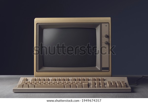 Vintage personal computer with keyboard on a\
desktop, outdated electronics\
concept