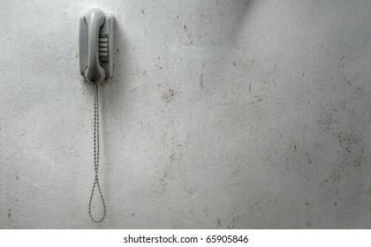 Vintage Phone Mounted Against A Dirty Wall