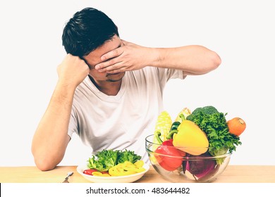 Vintage Photo Of Asian Man Showing Dislike Expression Of Fresh Colorful Vegetables Isolated Over White Background