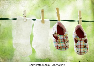 Vintage Photo Of Baby Clothes Hanging On The Clothesline.