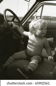 Vintage Photo Of Baby Girl In A Car