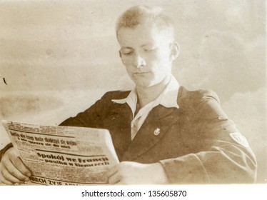 Vintage Photo Of Boy Reading A Newspaper (thirties)