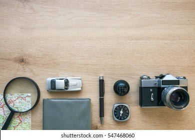 Vintage Photo Camera, Note Book, Compass, Pen, Magnifying Glass, Map, Car, Gear Knob on The Wooden Background