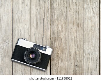 Vintage Photo Camera On A Wooden Table