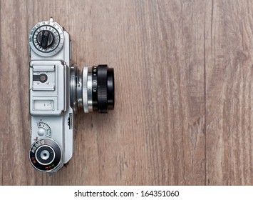 Vintage Photo Camera On A Wooden Background, Top View