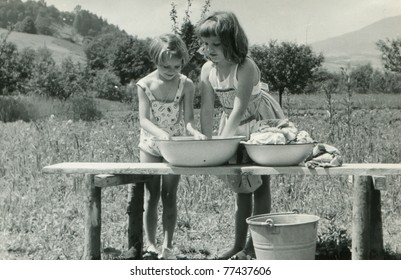 Vintage Photo Of Children Doing Laundry Outdoor (fifties)